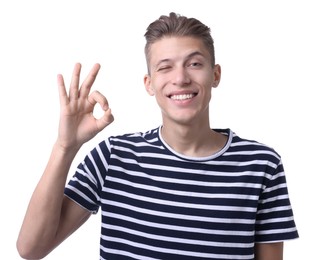 Photo of Happy young man showing OK gesture on white background