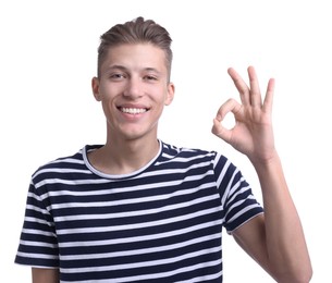 Photo of Happy young man showing OK gesture on white background