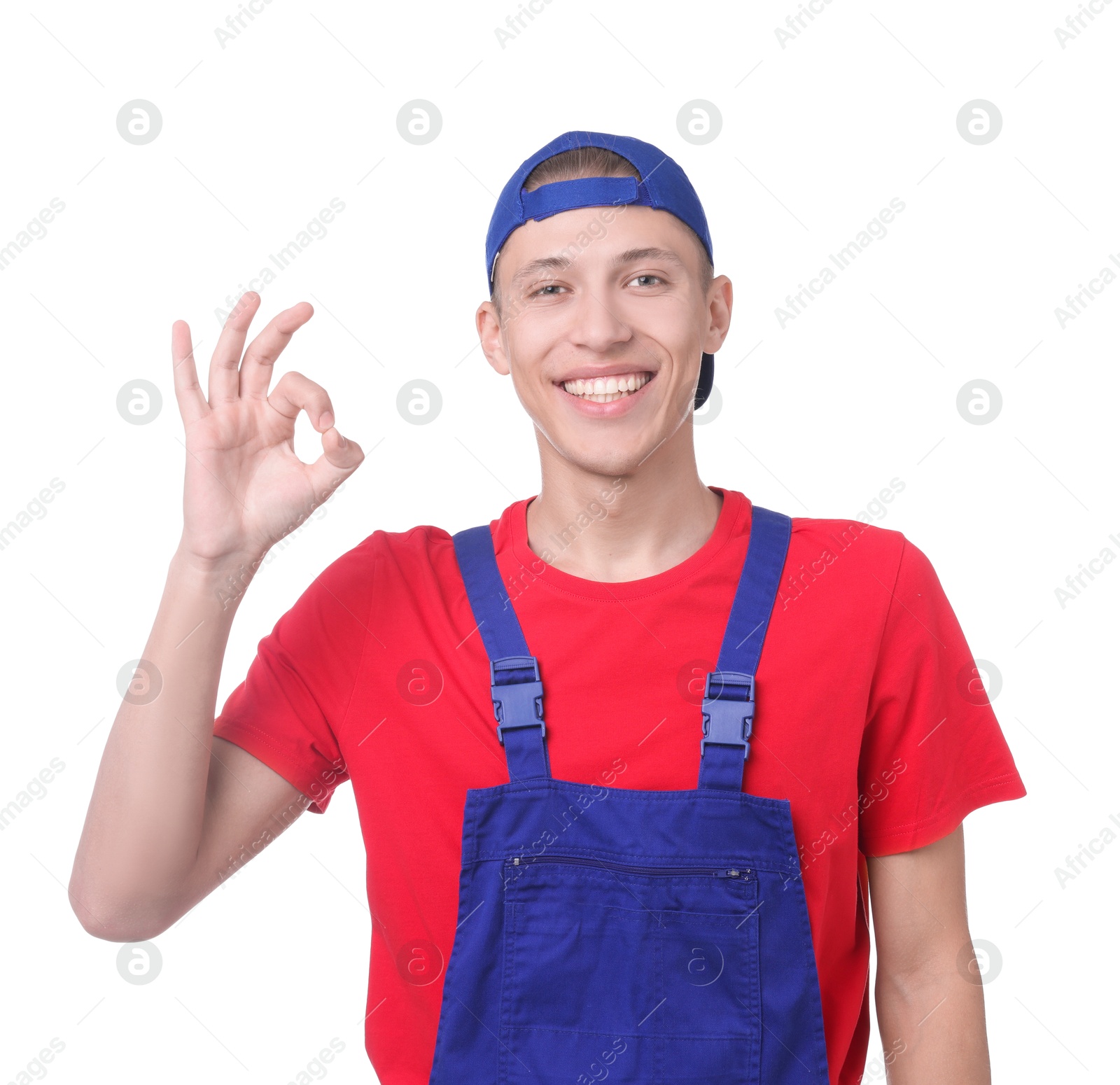 Photo of Happy young man in uniform showing OK gesture on white background