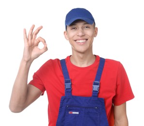 Photo of Happy young man in uniform showing OK gesture on white background