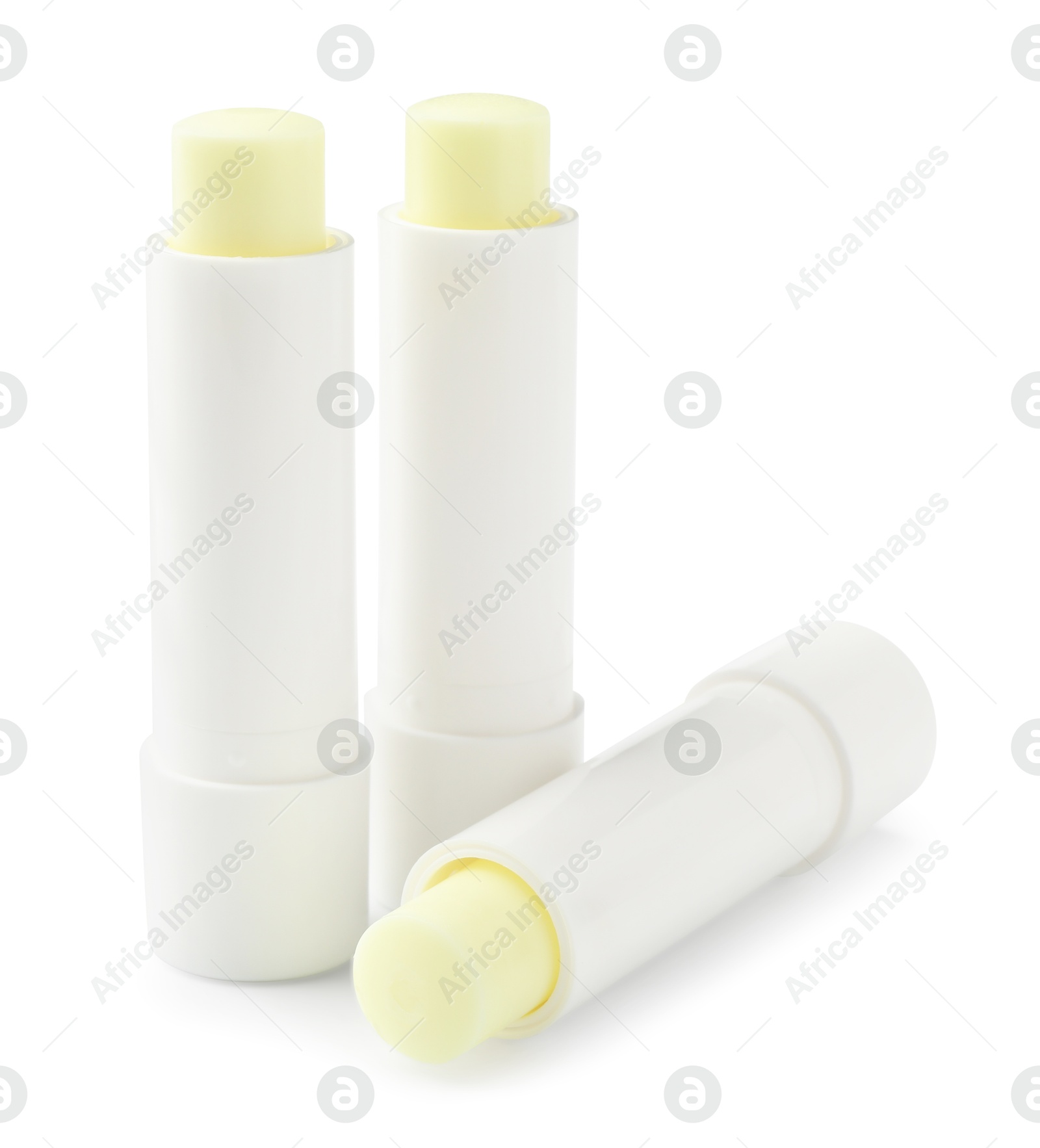 Photo of Lip balms isolated on white. Cosmetic product