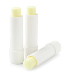 Photo of Lip balms isolated on white. Cosmetic product