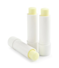 Photo of Lip balms isolated on white. Cosmetic product