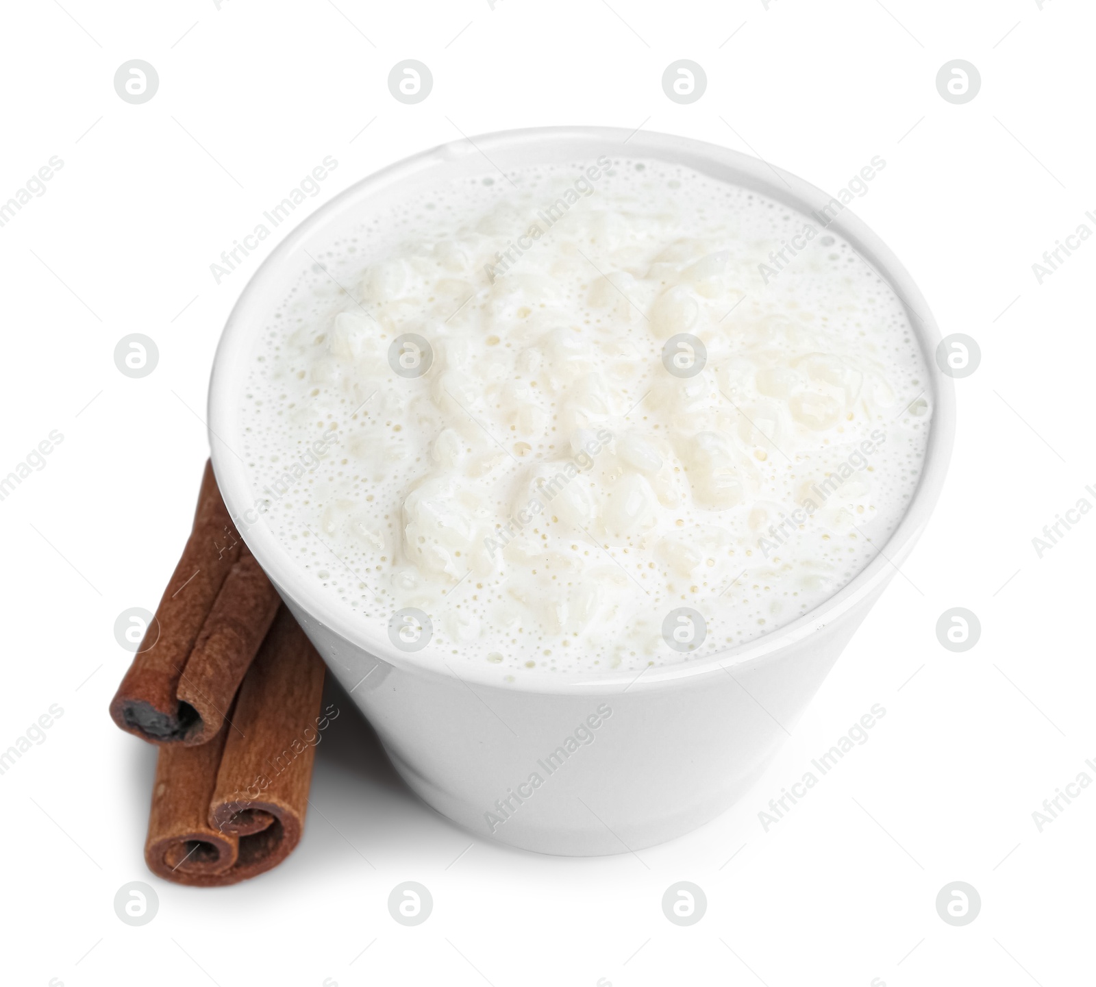 Photo of Delicious rice pudding with cinnamon sticks isolated on white