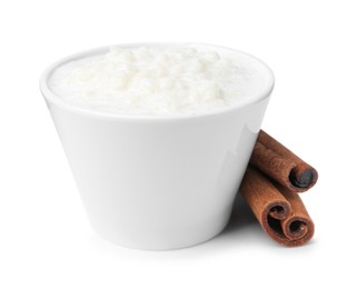 Photo of Delicious rice pudding with cinnamon sticks isolated on white