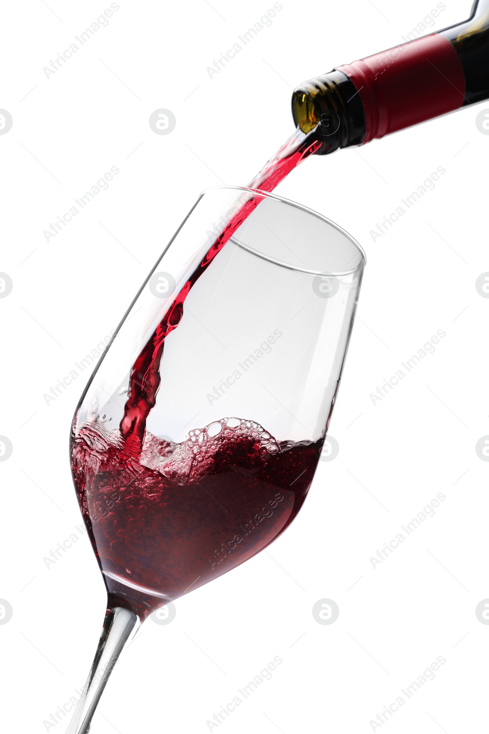 Photo of Pouring red wine into glass isolated on white