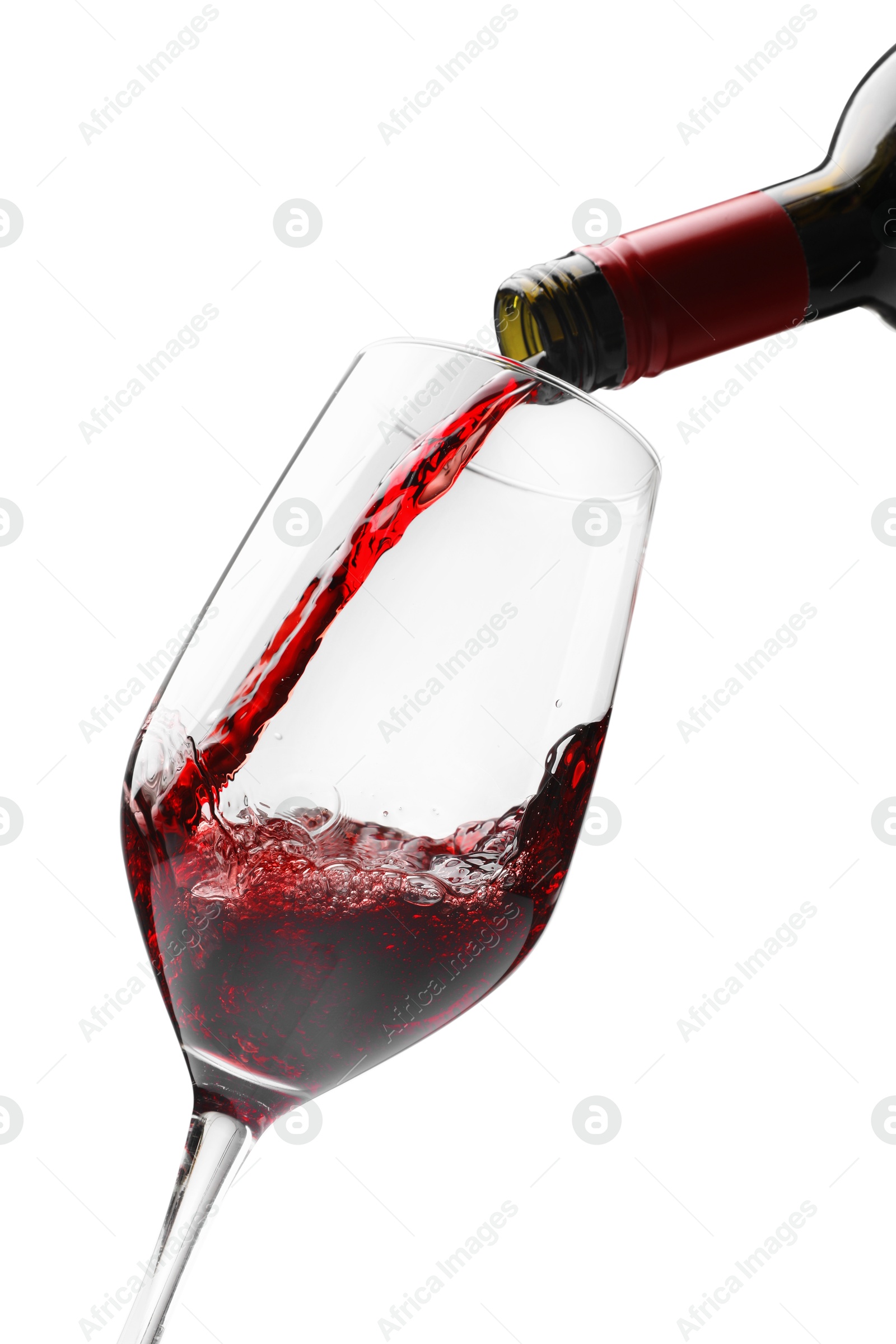 Photo of Pouring red wine into glass isolated on white