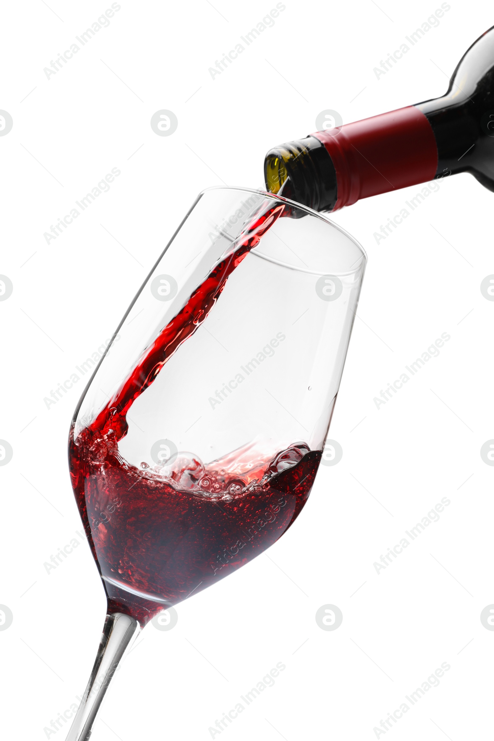 Photo of Pouring red wine into glass isolated on white