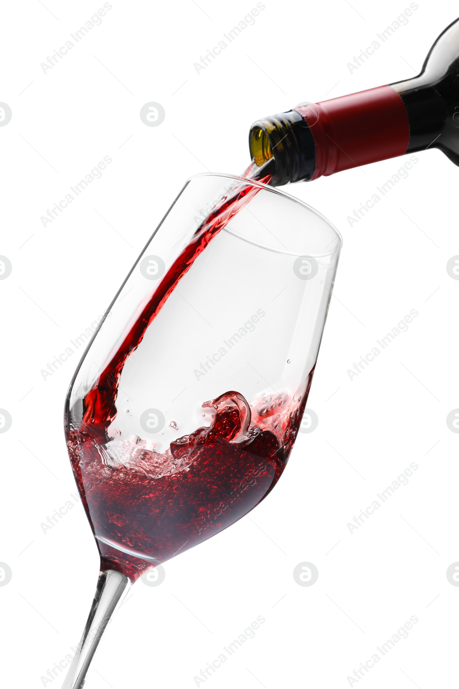 Photo of Pouring red wine into glass isolated on white