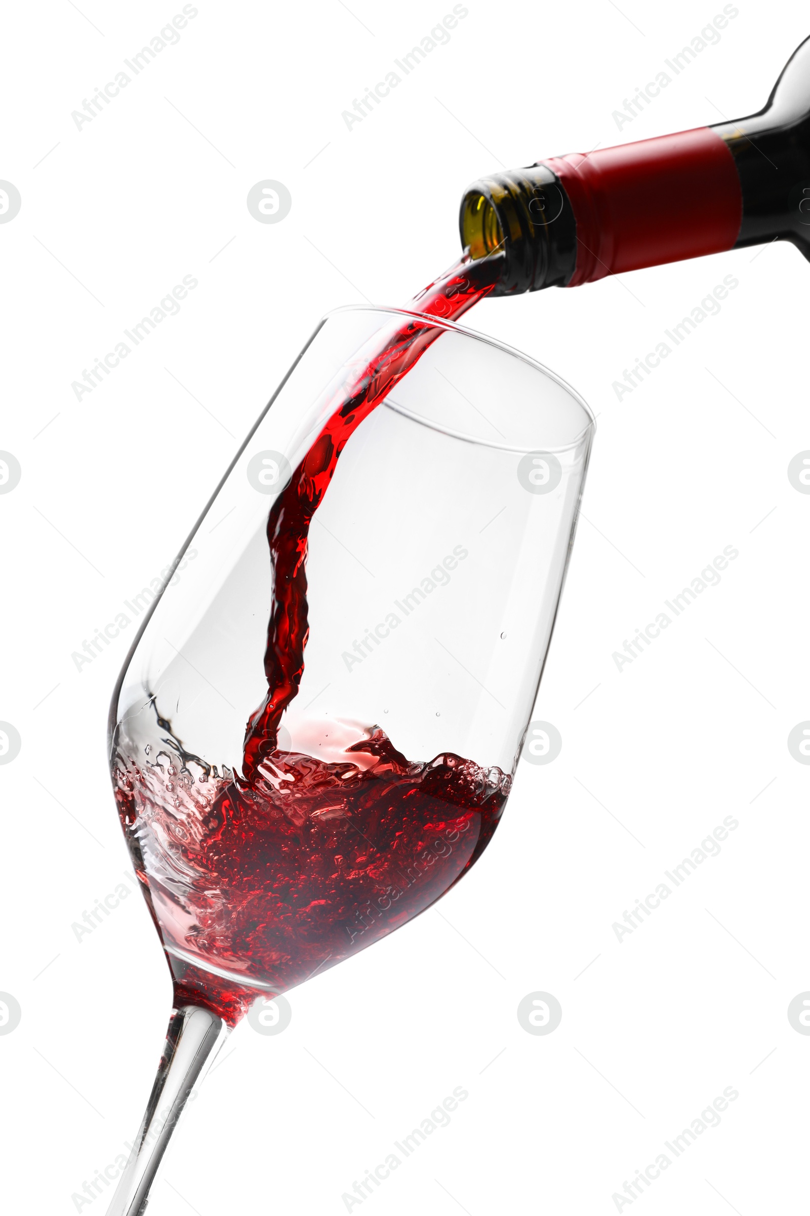 Photo of Pouring red wine into glass isolated on white