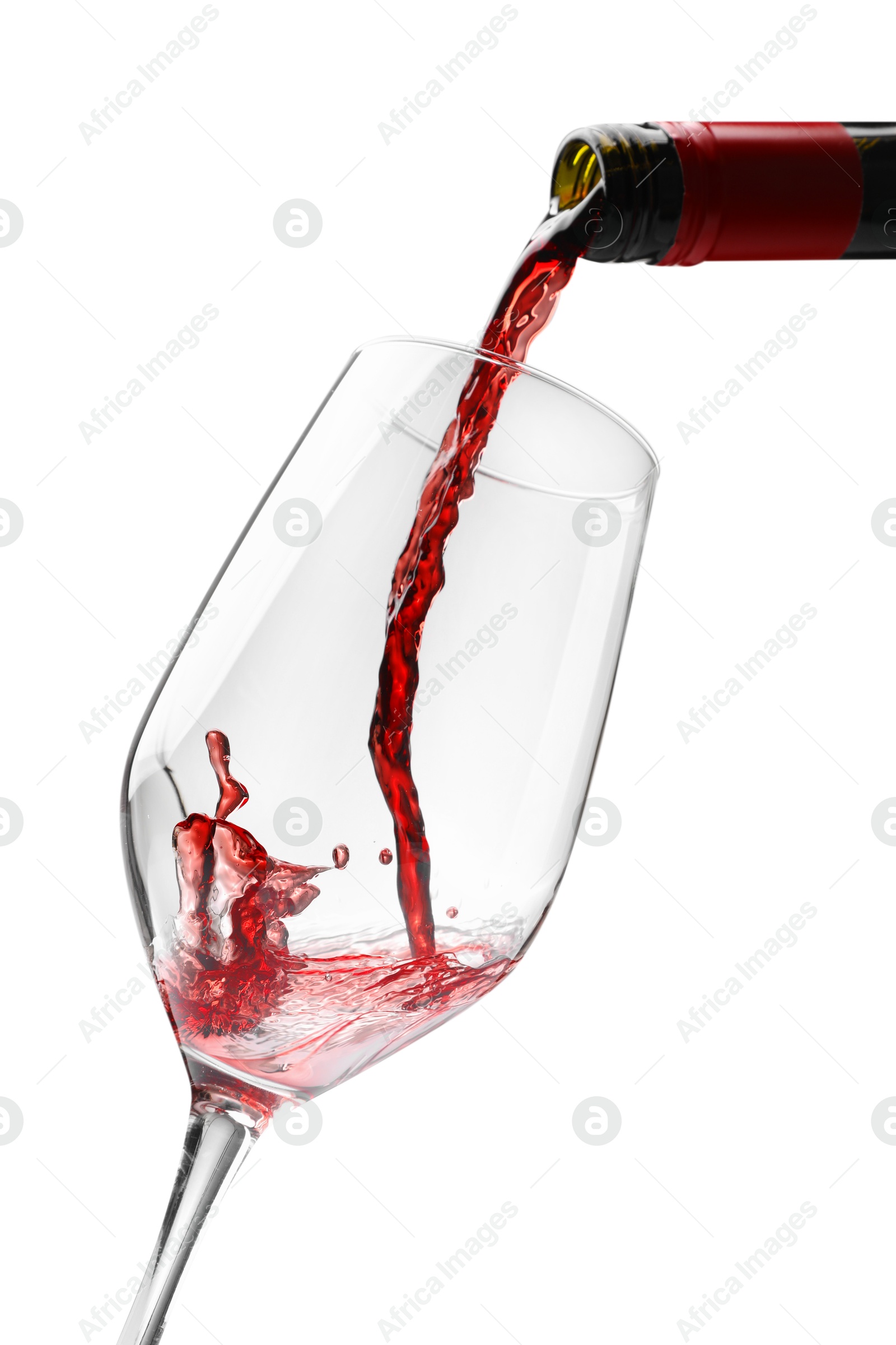 Photo of Pouring red wine into glass isolated on white