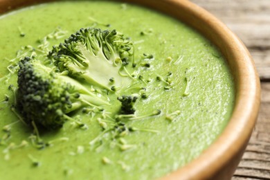 Photo of Delicious broccoli cream soup in bowl on table, closeup