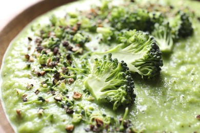 Photo of Delicious broccoli cream soup in bowl, closeup