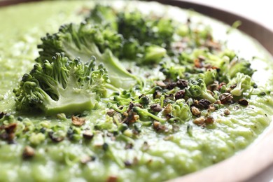 Photo of Delicious broccoli cream soup in bowl, closeup