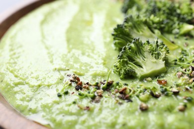 Photo of Delicious broccoli cream soup in bowl, closeup