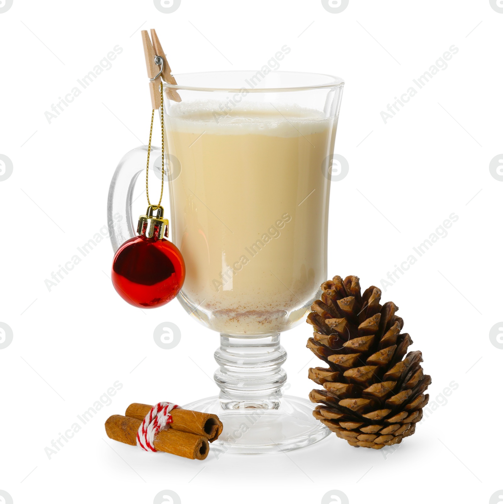 Photo of Tasty Christmas cocktail (eggnog) in glass, pine cone and baubles isolated on white