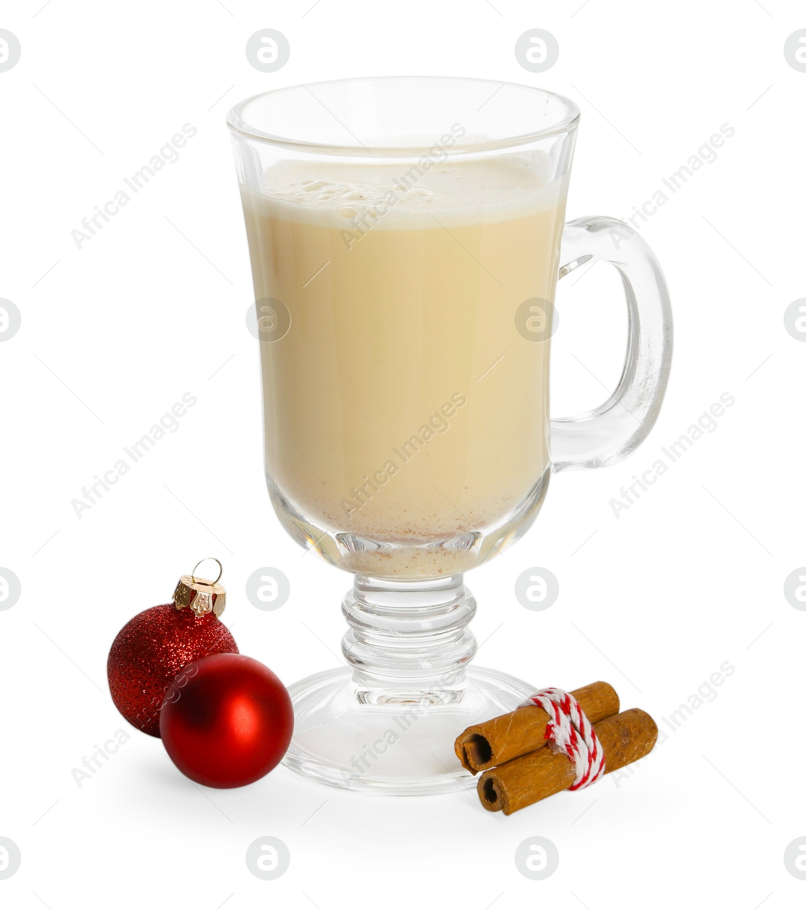 Photo of Tasty Christmas cocktail (eggnog) in glass, cinnamon and baubles isolated on white