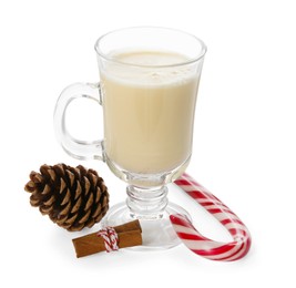 Photo of Tasty Christmas cocktail (eggnog) in glass, cinnamon, pine cone and candy cane isolated on white