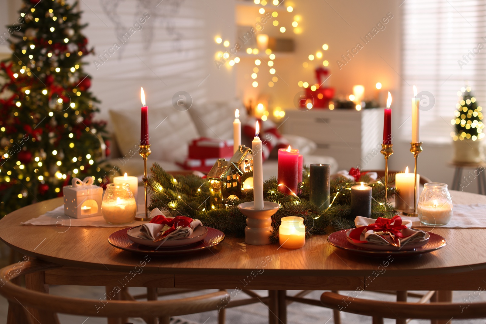 Photo of Festive table setting in room decorated for Christmas. Bokeh effect