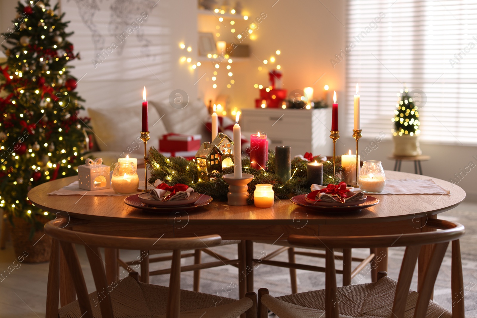 Photo of Festive table setting in room decorated for Christmas. Bokeh effect