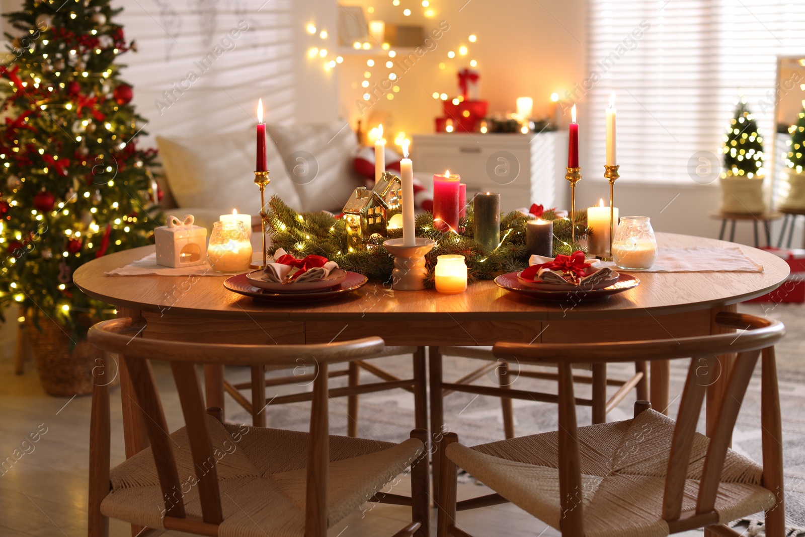 Photo of Festive table setting in room decorated for Christmas. Bokeh effect