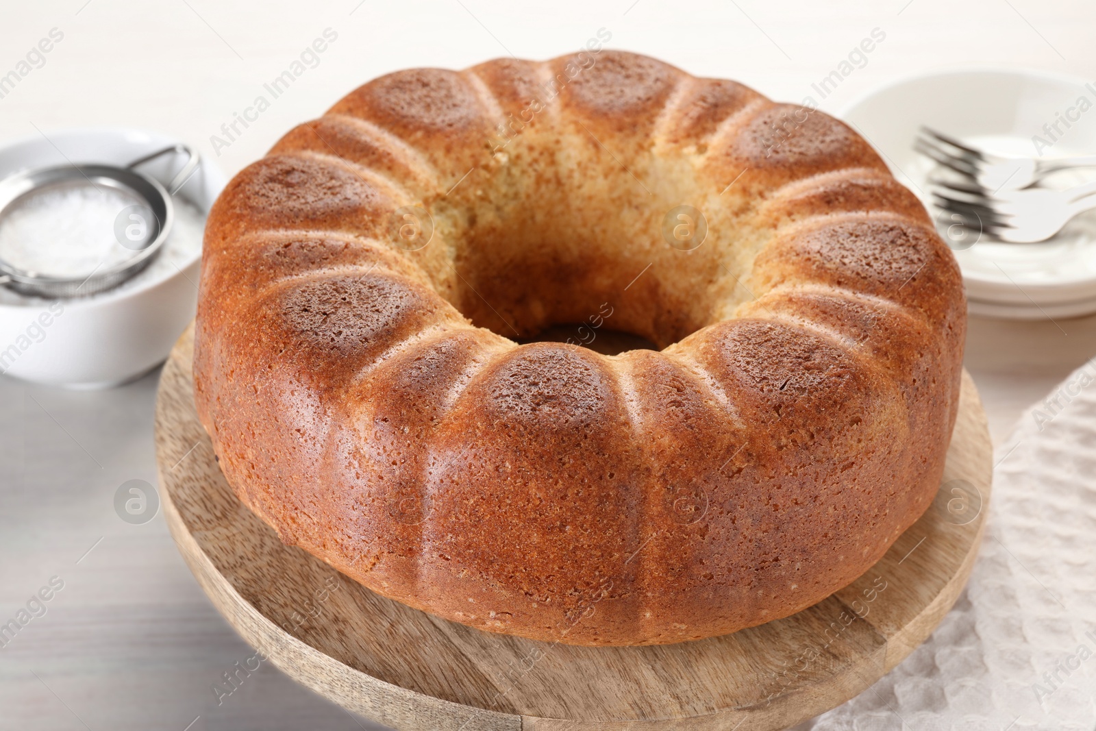 Photo of Freshly baked sponge cake served on white table, closeup