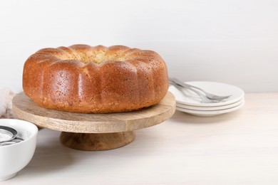 Photo of Freshly baked sponge cake served on white wooden table