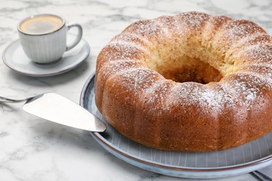 Photo of Freshly baked sponge cake, server and coffee on white marble table, closeup