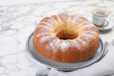 Photo of Freshly baked sponge cake and coffee on white marble table