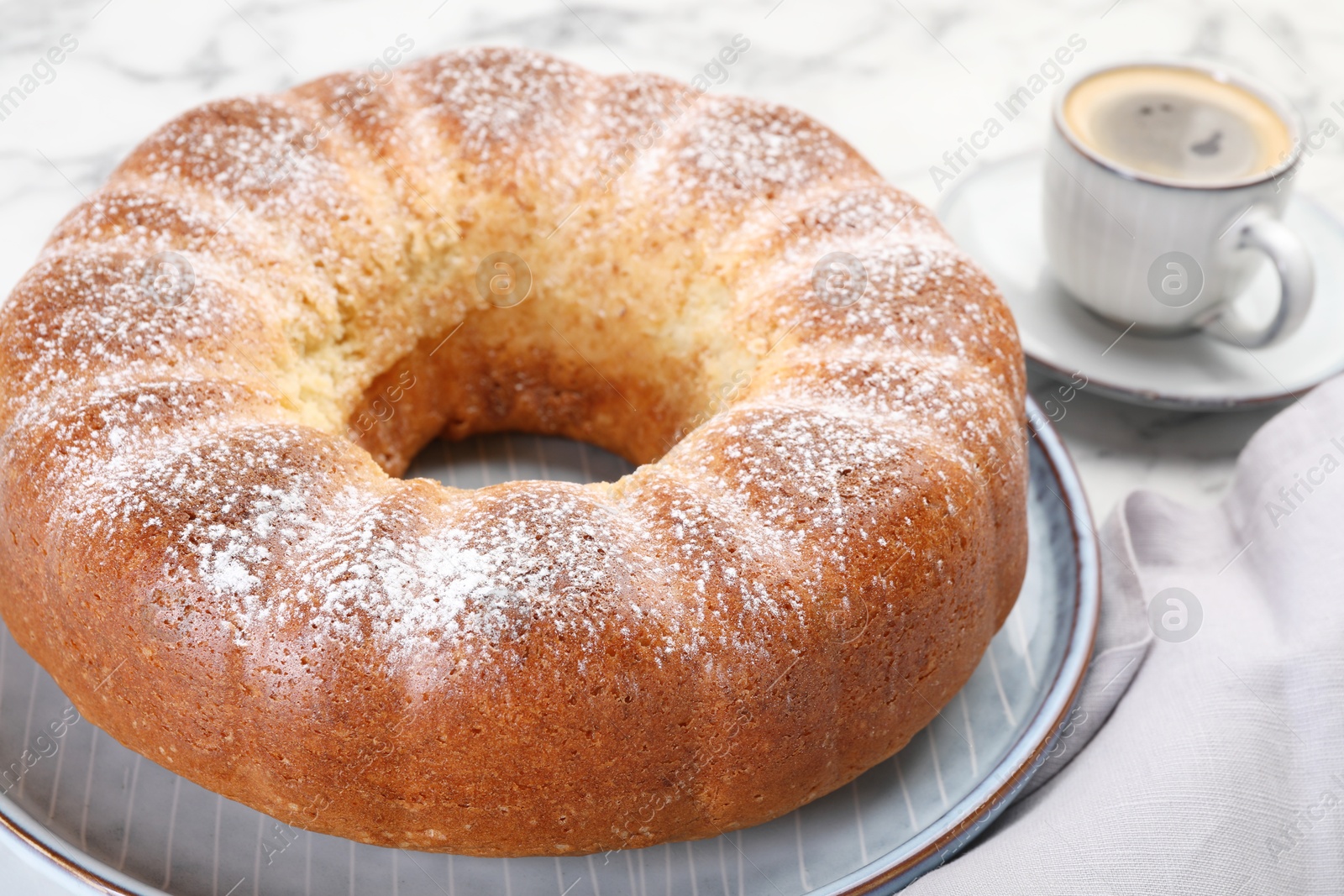 Photo of Freshly baked sponge cake and coffee on table, closeup