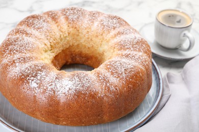 Photo of Freshly baked sponge cake and coffee on table, closeup