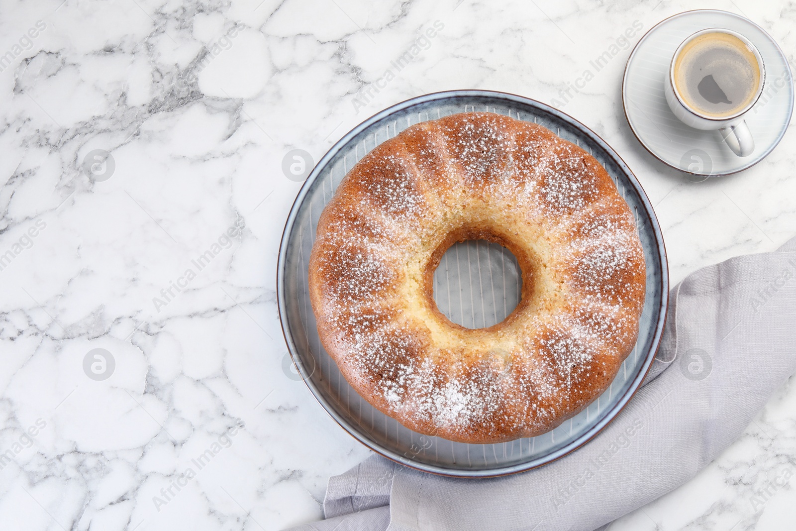 Photo of Freshly baked sponge cake and coffee on white marble table, top view. Space for text