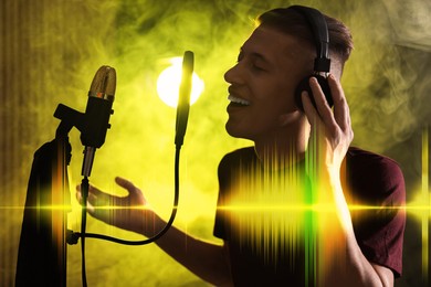 Vocalist with headphones singing into microphone in professional record studio. Sound waves