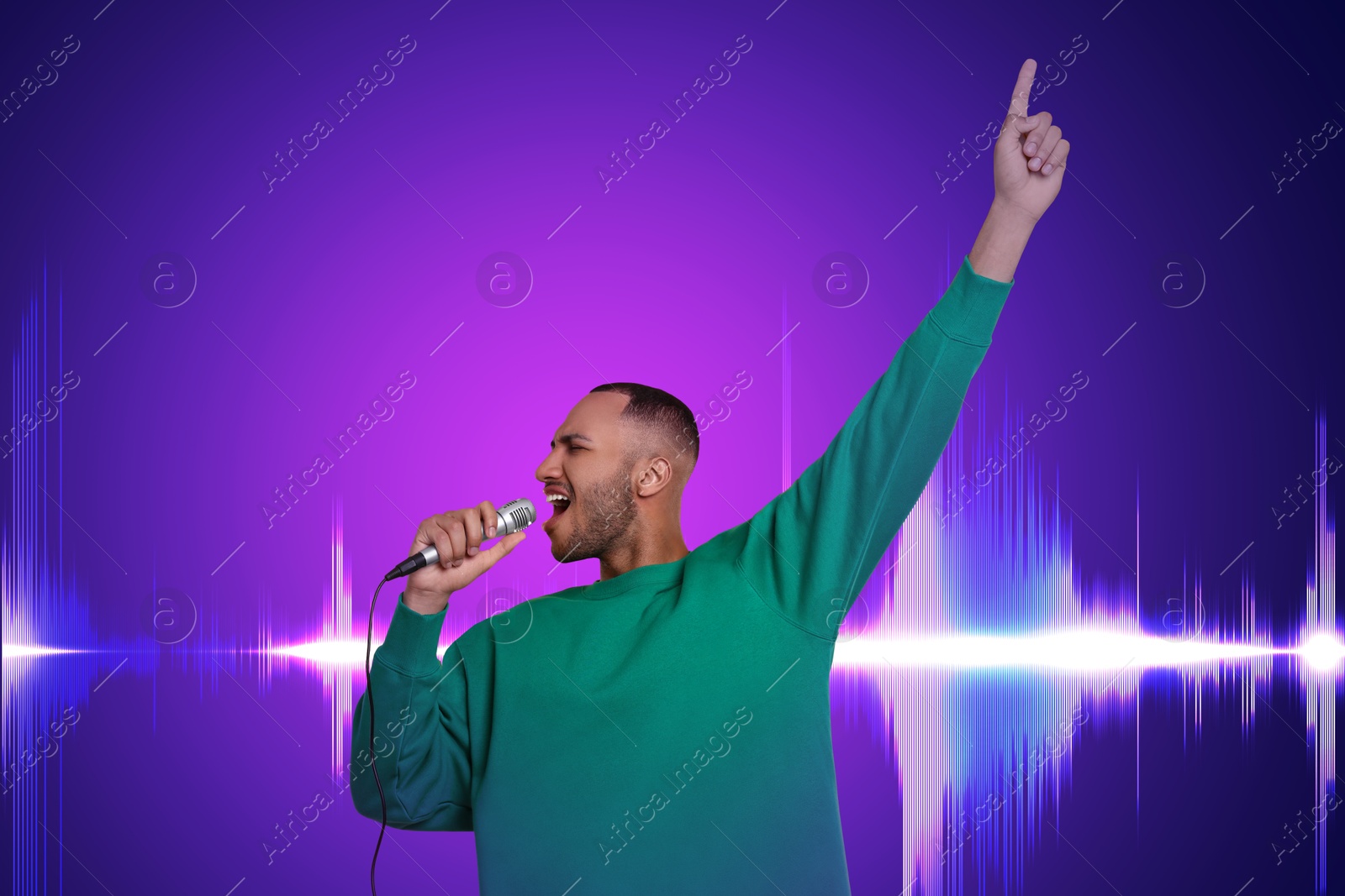 Image of Handsome man with microphone singing on violet gradient background. Sound waves