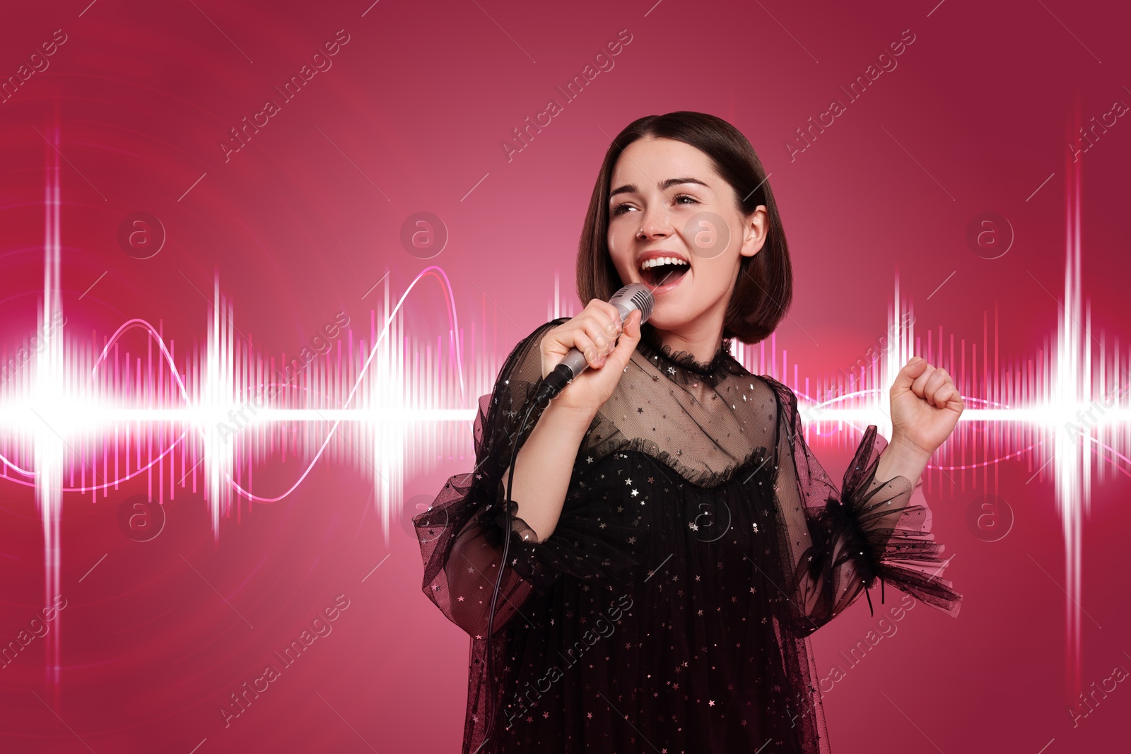 Image of Beautiful young woman with microphone singing on dark pink background. Sound waves