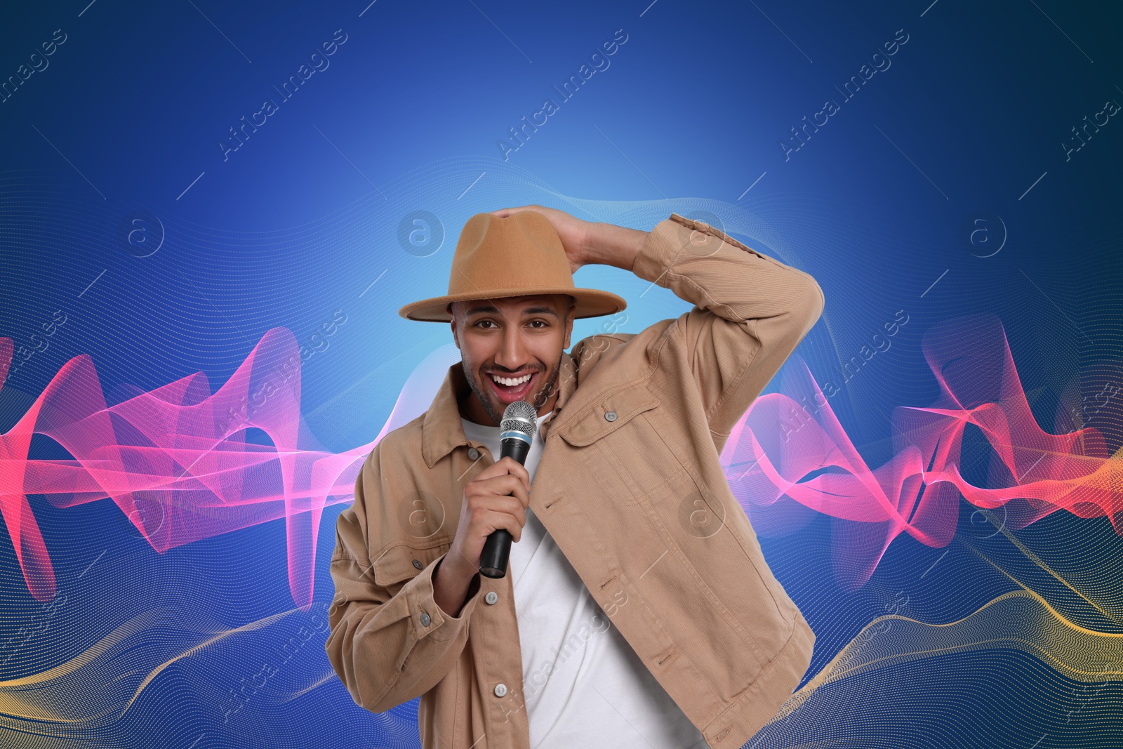 Image of Handsome man with microphone singing on blue gradient background. Sound waves