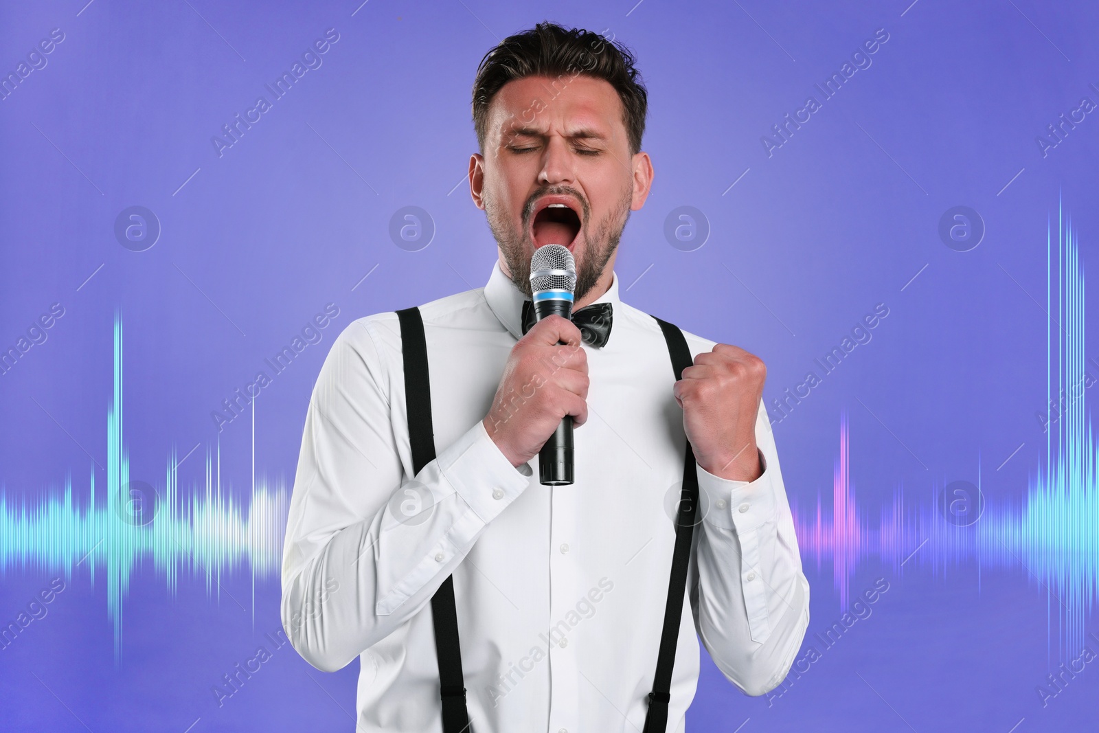 Image of Handsome man with microphone singing on color background. Sound waves