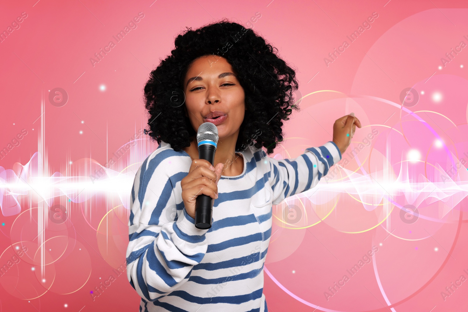 Image of Beautiful woman with microphone singing on pink background. Sound waves