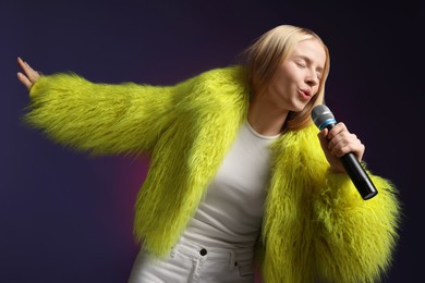 Photo of Talented singer in faux fur performing on dark background