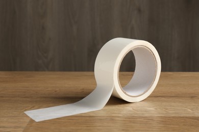 Photo of Roll of masking tape on wooden table