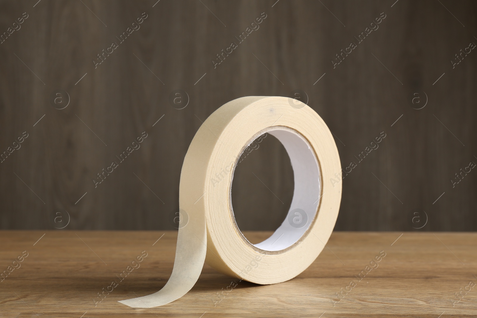 Photo of Roll of masking tape on wooden table