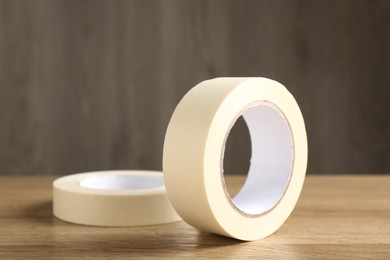 Rolls of masking tape on wooden table, closeup