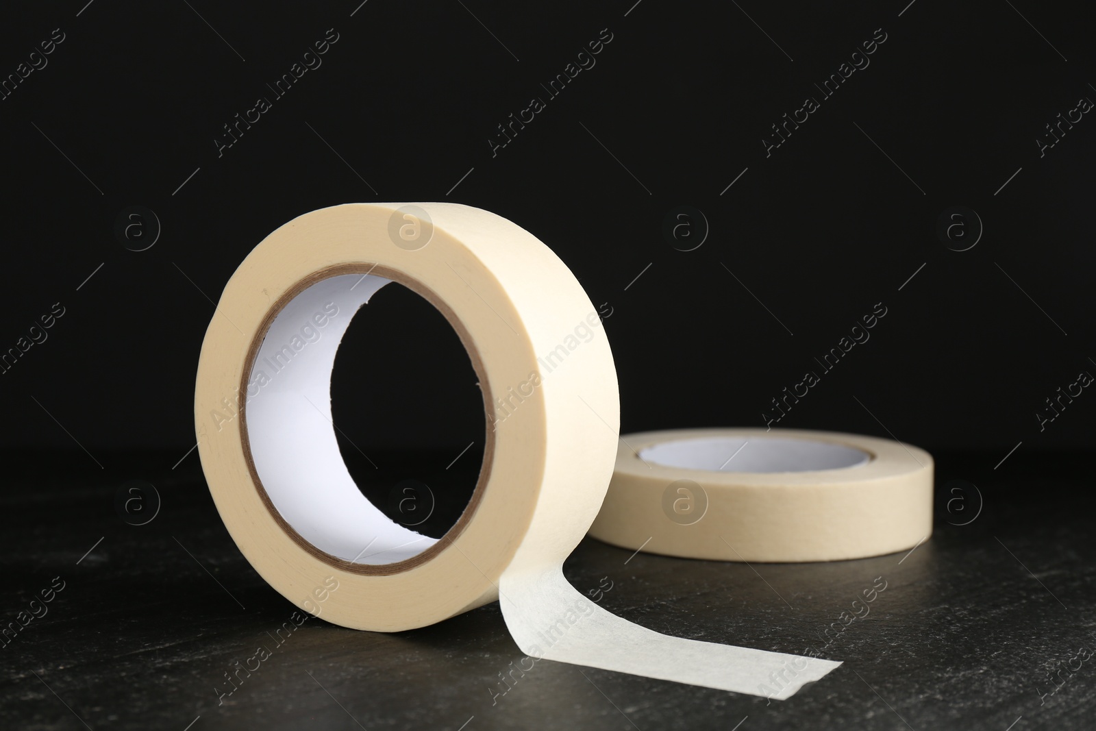 Photo of Rolls of masking tape on black table