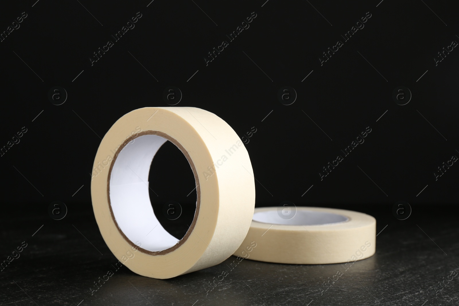 Photo of Rolls of masking tape on black table