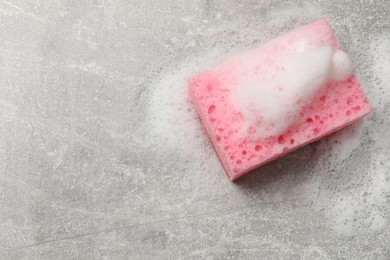 Photo of Sponge and foam on light grey table, top view. Space for text