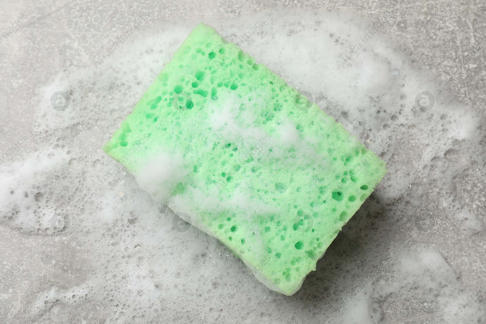 Photo of Sponge and foam on light grey table, top view