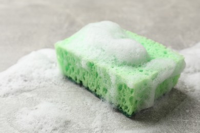 Photo of Sponge and foam on light grey table, closeup