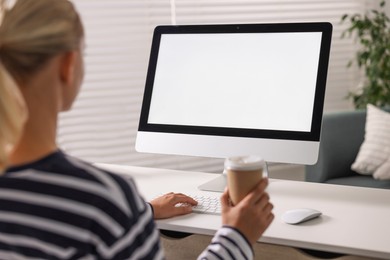 Photo of Woman working with computer monitor at table in office. Mockup for design