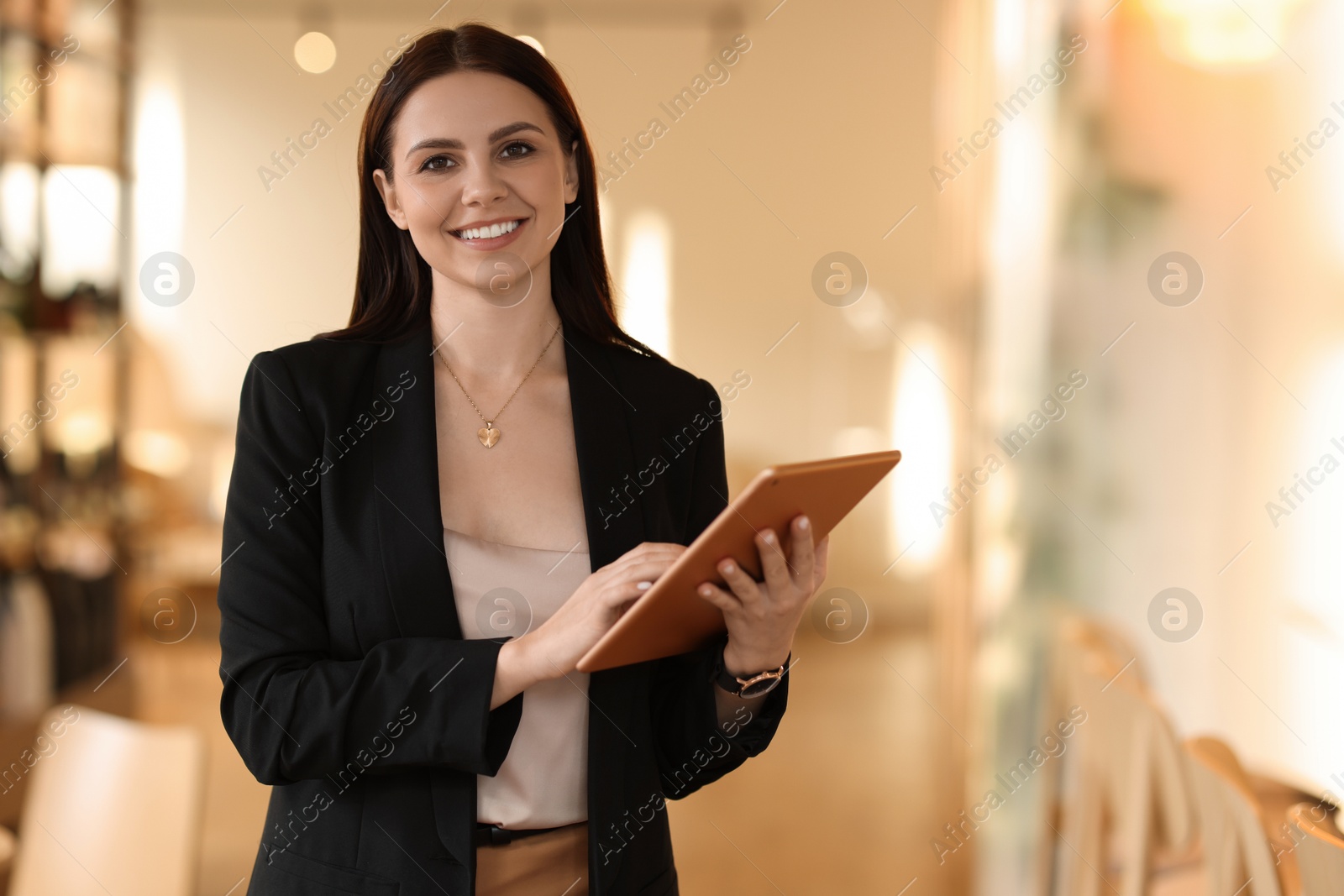 Photo of Woman in stylish formal suit with tablet indoors