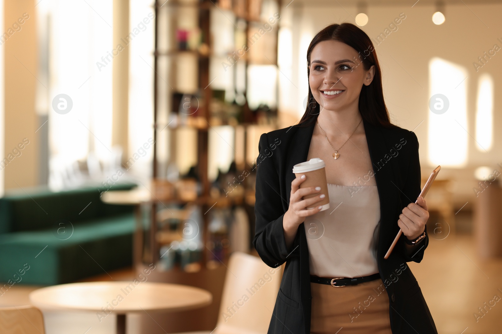 Photo of Woman in stylish formal suit with tablet and coffee indoors. Space for text